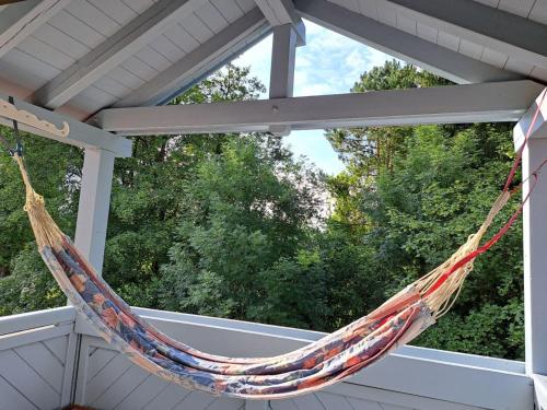 a hammock hanging from a roof on a porch at Charming Apartment near Lake in Utting am Ammersee