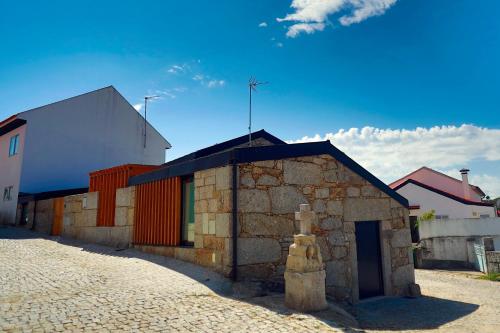 a small stone building on the side of a street at Villa Lamegal in Pinhel