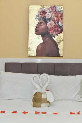 a picture of a woman with a basket on a bed at Sun City Accomodation in Maputo