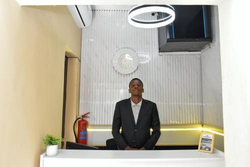 a man sitting on a desk in an office at Sun City Accomodation in Maputo