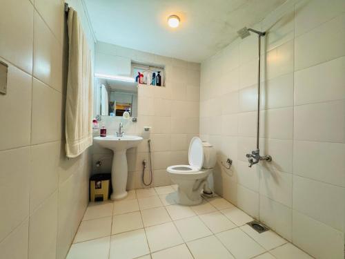 a bathroom with a toilet and a sink and a shower at The Hermitage Cottage-Exclusive Mountain Escape in Murree