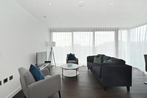 a living room with a couch and two chairs and a table at Access Tower Hill in London