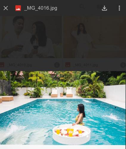a woman in a pool in an inflatable pool in the water at Villa del Sol 1 in Guinauayan