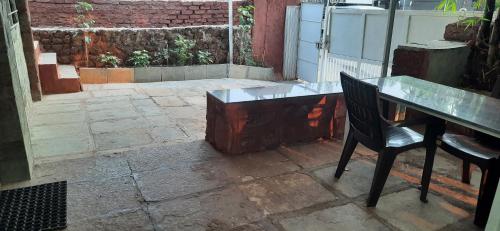 a desk and a chair sitting next to a table at Leela villa - Ancient Redstone Escape in Panchgani