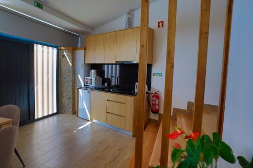 a living room with a kitchen with a microwave at Villa Lamegal in Pinhel