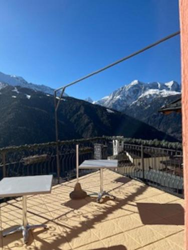 a balcony with benches and a view of mountains at Albergo Eden in Ponte di Legno