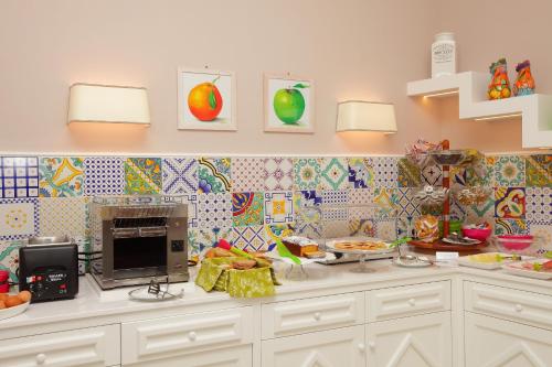 a kitchen with a counter with food on it at Hotel Villa Di Sorrento in Sorrento