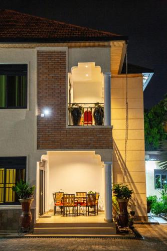 a house with a table and chairs on the porch at Rebero A3s apartment in Kigali