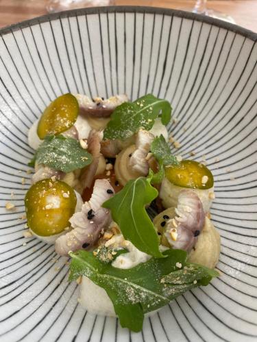 a plate of food with mushrooms and green leaves at Manoir de Rieuzal in Loubressac