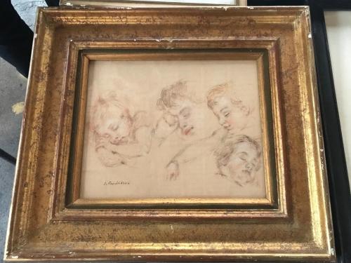a drawing of three babies in a gold frame at Manoir de Rieuzal in Loubressac
