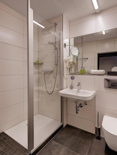 a bathroom with a shower and a sink at Hotel Central in Hof