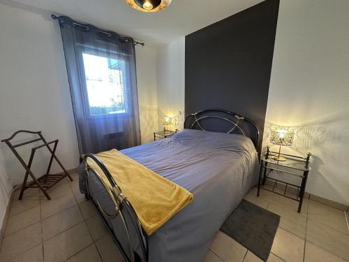 a bedroom with a bed with a yellow blanket on it at Adour e vita in Pontonx-sur-lʼAdour