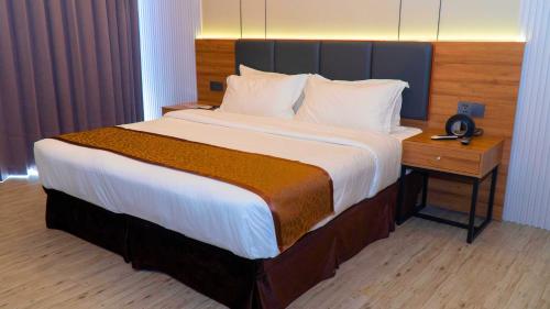 Ένα ή περισσότερα κρεβάτια σε δωμάτιο στο Vienna Hotel
