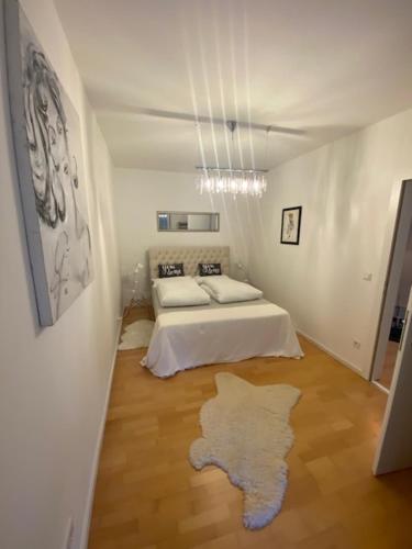 a bedroom with a bed and a rug on the floor at FERIEN DOMIZIL Neusiedlersee in Breitenbrunn