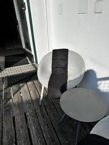 a bench and a table and a chair on a porch at FERIEN DOMIZIL Neusiedlersee in Breitenbrunn