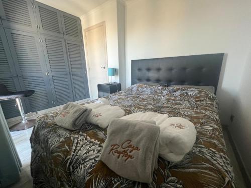 a bedroom with a bed with towels on it at Casa rooftop jacuzzi and magnificent sea view in Albufeira