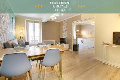 a dining room and living room with a table and chairs at " Loutrein Lodge " Hyper Centre - Calme - WiFi in Saint-Girons