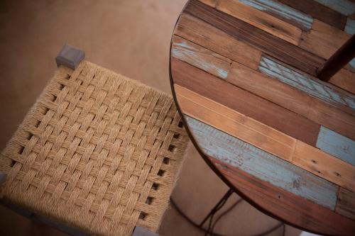 a wooden chair sitting next to a wooden table at Hotel Sa Volta in Es Pujols
