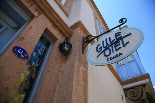 a sign on the side of a building at Gule Cunda in Ayvalık