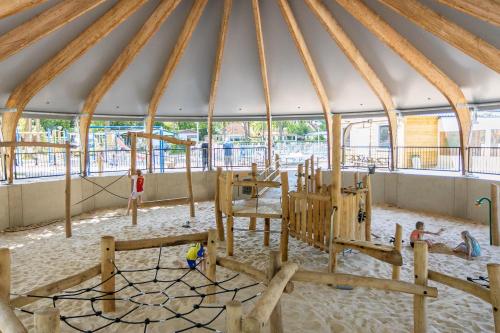 a gym in a igloo with wooden play equipment at Casa Emanuèl in IJhorst