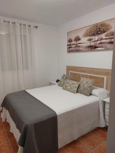 a bedroom with a bed in a white room at La Labranza del Bosque in El Bosque