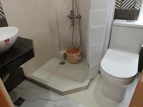 a bathroom with a toilet and a sink and a shower at Aguada Hills Residence in Puerto Galera