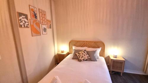 une chambre avec un lit avec deux lampes dessus dans l'établissement L'Emile - Près des Halles - Parking privé, à Pau