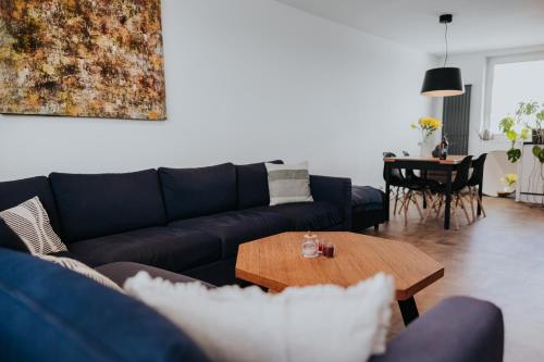 a living room with a couch and a table at Valdštejn - pohoda v Českém ráji in Jičín