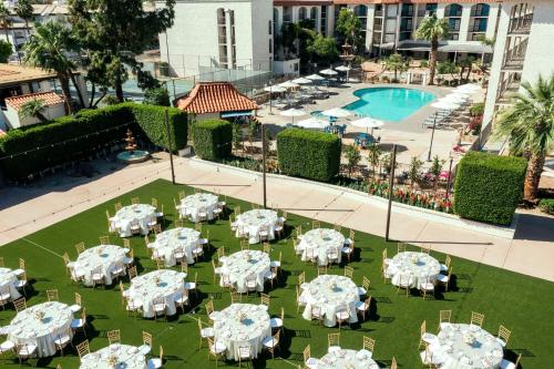 an overhead view of a restaurant with white tables and chairs at Embassy Suites by Hilton Scottsdale Resort in Scottsdale