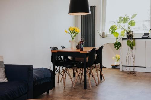 a dining room table with chairs and a bottle of wine at Valdštejn - pohoda v Českém ráji in Jičín