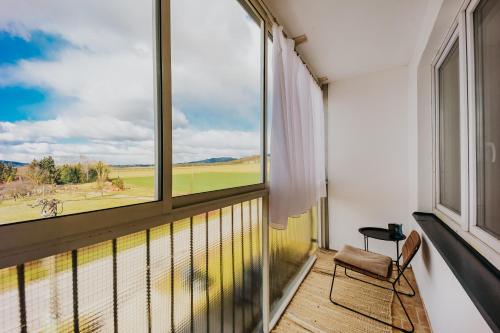 a balcony with a chair and a large window at Valdštejn - pohoda v Českém ráji in Jičín