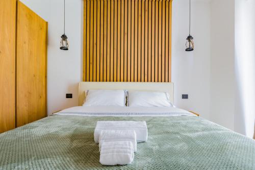 a bedroom with a bed with two towels on it at Gatto Matto in Brolo