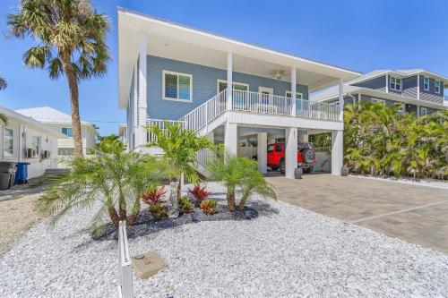 a large blue house with palm trees in front of it at Welcome to Mermaid Bay Vacation Rental - 261 Delmar home in Fort Myers Beach