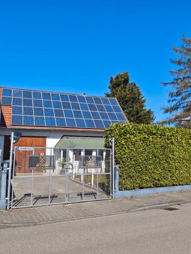 a building with a lot of solar panels on the roof at Bei s' Herrs in Rheinmunster