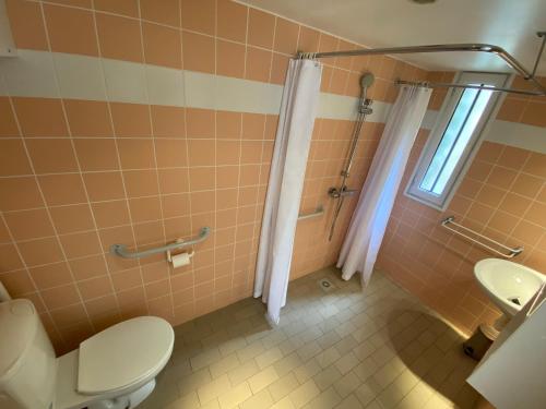 a bathroom with a toilet and a shower and a sink at Terres de France - Le Domaine des Vans in Chambonas