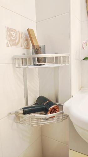 a white bathroom with a shelf next to a sink at Lily's home Jing'an Temple in Shanghai