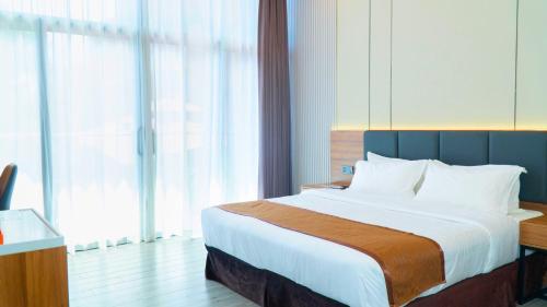Ένα ή περισσότερα κρεβάτια σε δωμάτιο στο Vienna Hotel