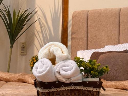 two towels in a basket on a table at Sunset homes in Downtown Cairo in Cairo