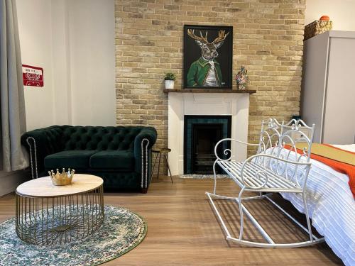 a living room with a couch and a fireplace at Studio flat in Fitzrovia in London