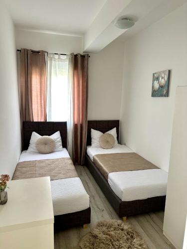 a bedroom with two beds and a window at Villa Iris in Trbounje