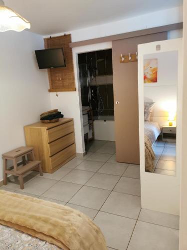a room with a bedroom with a bed and a mirror at T2 cosy Pierrefeu du var in Pierrefeu-du-Var