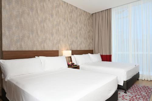 a hotel room with two beds and a window at Comfort Hotel Riyadh Olaya in Riyadh