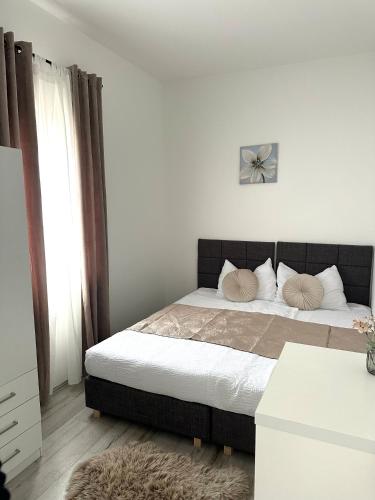 a bedroom with a bed with two pillows on it at Villa Iris in Trbounje