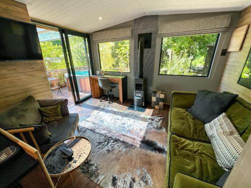 a living room with a couch and a table at The Cabins at Phantom Acres in Hout Bay