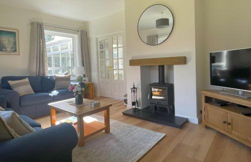 a living room with a couch and a fire place at Fern Cottage in Portinscale