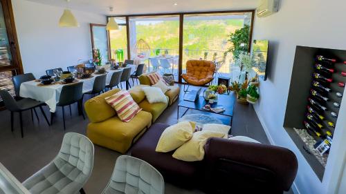 a living room with couches and a table and chairs at Casas Colgadas Alcalá del Júcar in Alcalá del Júcar
