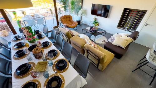 a living room with a table and a couch at Casas Colgadas Alcalá del Júcar in Alcalá del Júcar
