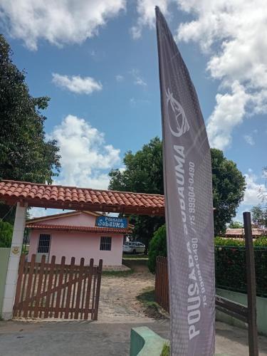 a flag sign in front of a building at Pousada subauma in Subaúma