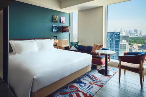a hotel room with a bed and a large window at Hotel Indigo Tokyo Shibuya in Tokyo