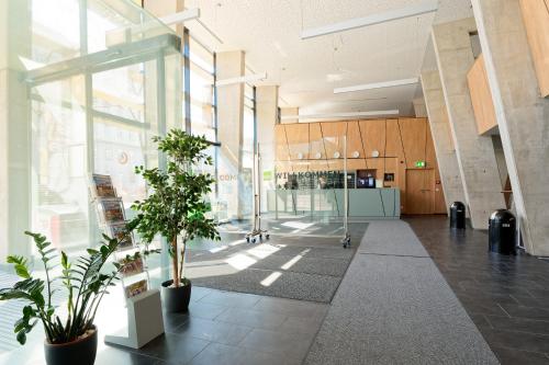 a lobby of a building with plants in it at Jugendgästehaus Brigittenau &Brigittenau Youth Palace in Vienna